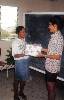 013 (320Wx500H) - Melicia Mathison, a student at Mona High School, Presents Miss Jamaica World 1997 Selena Delgado with a gift after she delivered a wide-ranging address on issues of self-esteem. choosing a career, spirituality nad setting goals. Selena was at the Knowledg 