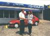 A3 (492Wx359H) - Imani receives key to her prize car in background 